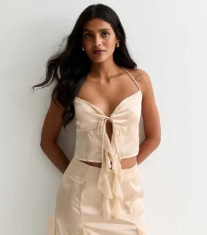 Champagne satijnen top met bandjes aan de voorkant