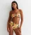 Bandeau-top van tropische palm met schelp en hoog getailleerde bodem met ruches