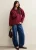 Oversized trui met rode strik-patch