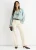 Saliegroene losvallende blouse met brede ruches